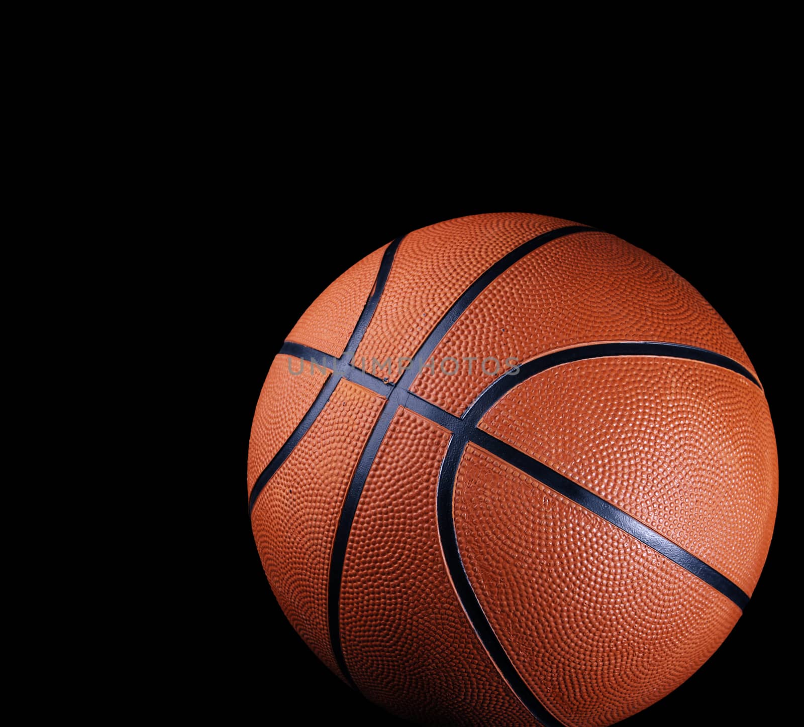 One basketball on black background 