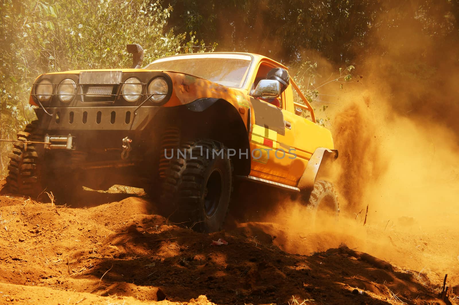 Racer at terrain racing car competition, the car try to cross extreme off road with red earth,  wheel make splash of soil and dusty air, competitor  adventure in championship spirit 