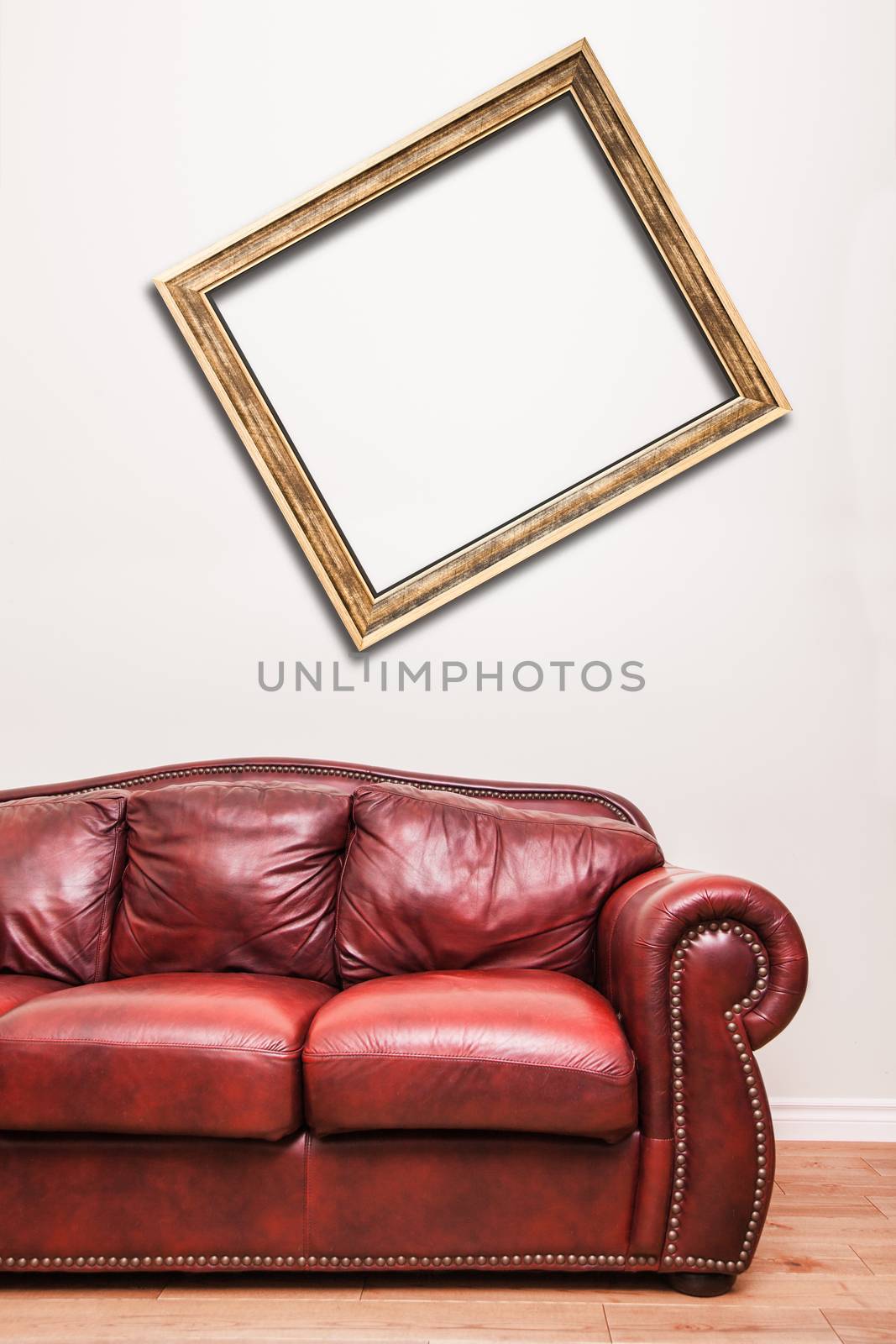 Luxurious Red Leather Couch in front of a blank crooked frame to ad your text, logo, images, etc.