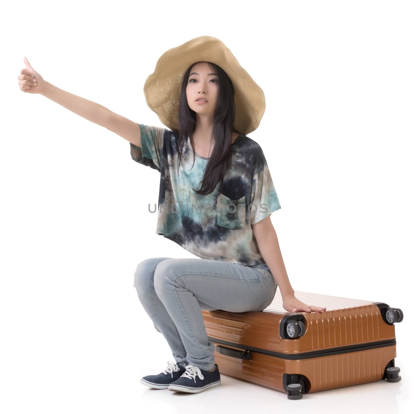 Asian young traveling woman hitchhiking, full length portrait isolated on white.