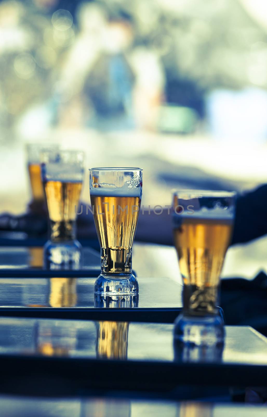 glasses of beer on a table in a restaurant 