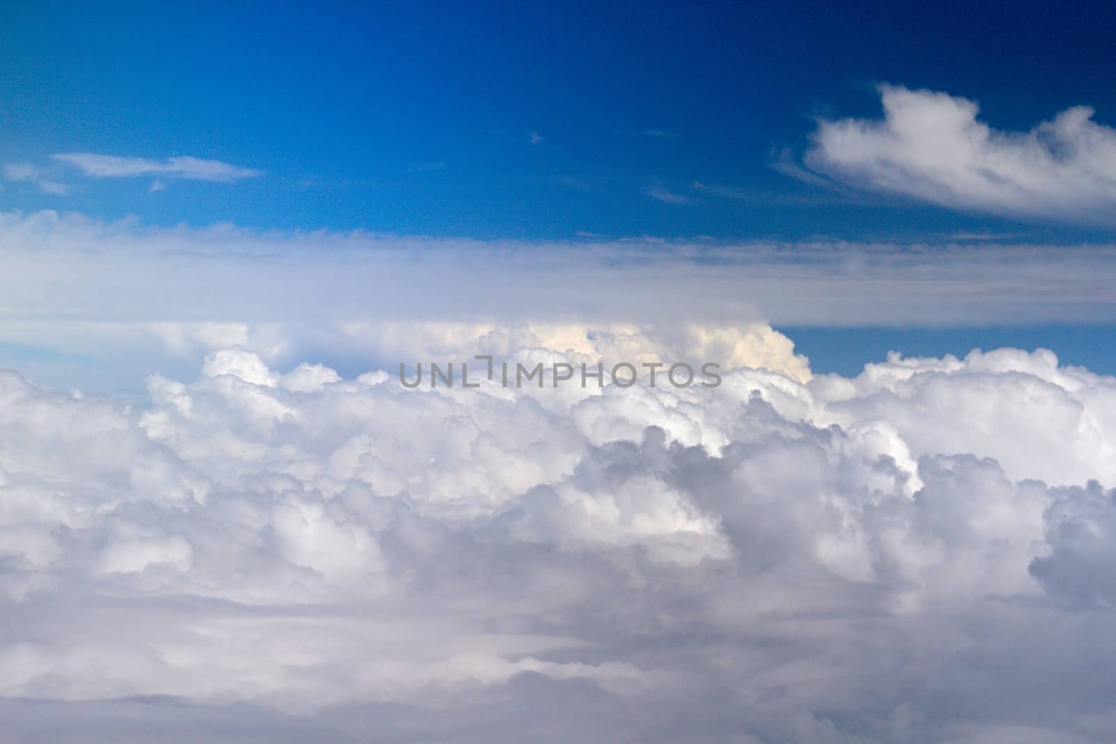 Photo shows details of white clouds and blue sky.