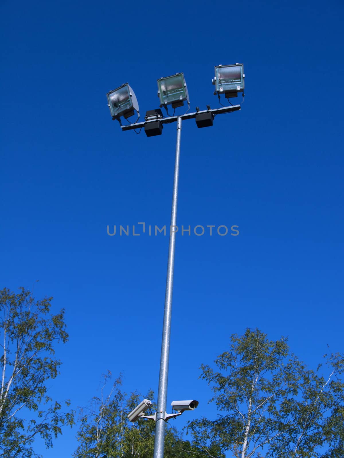 Stadium light against blue sky in Riga