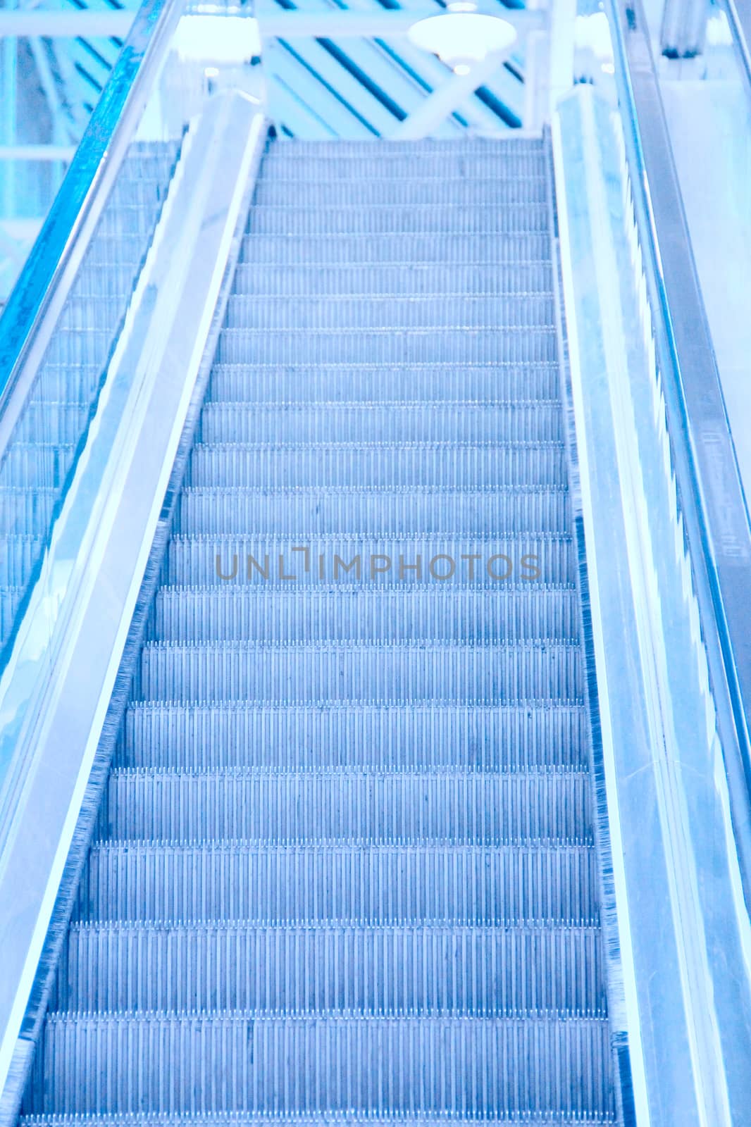 Perspective of escalator toned in blue color
