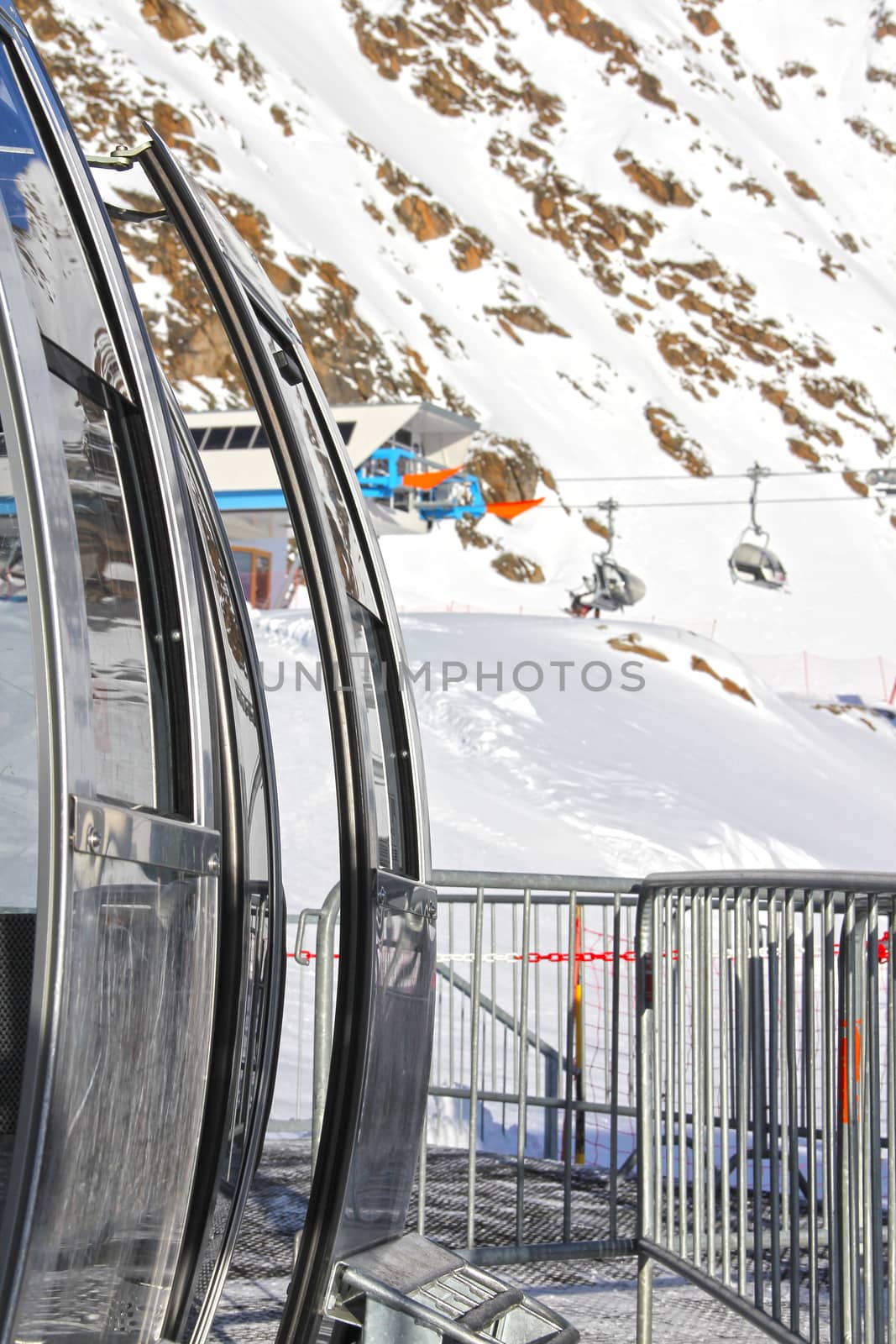 Ski lift chairs on bright winter day in Alp mountains