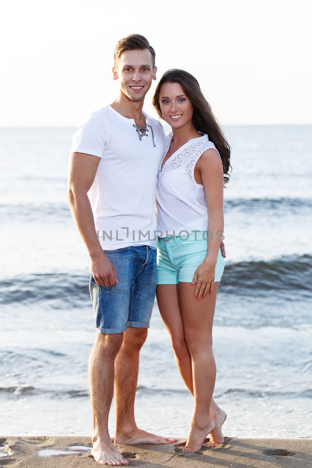 Summer, sea. Cute, lovely couple on the beach
