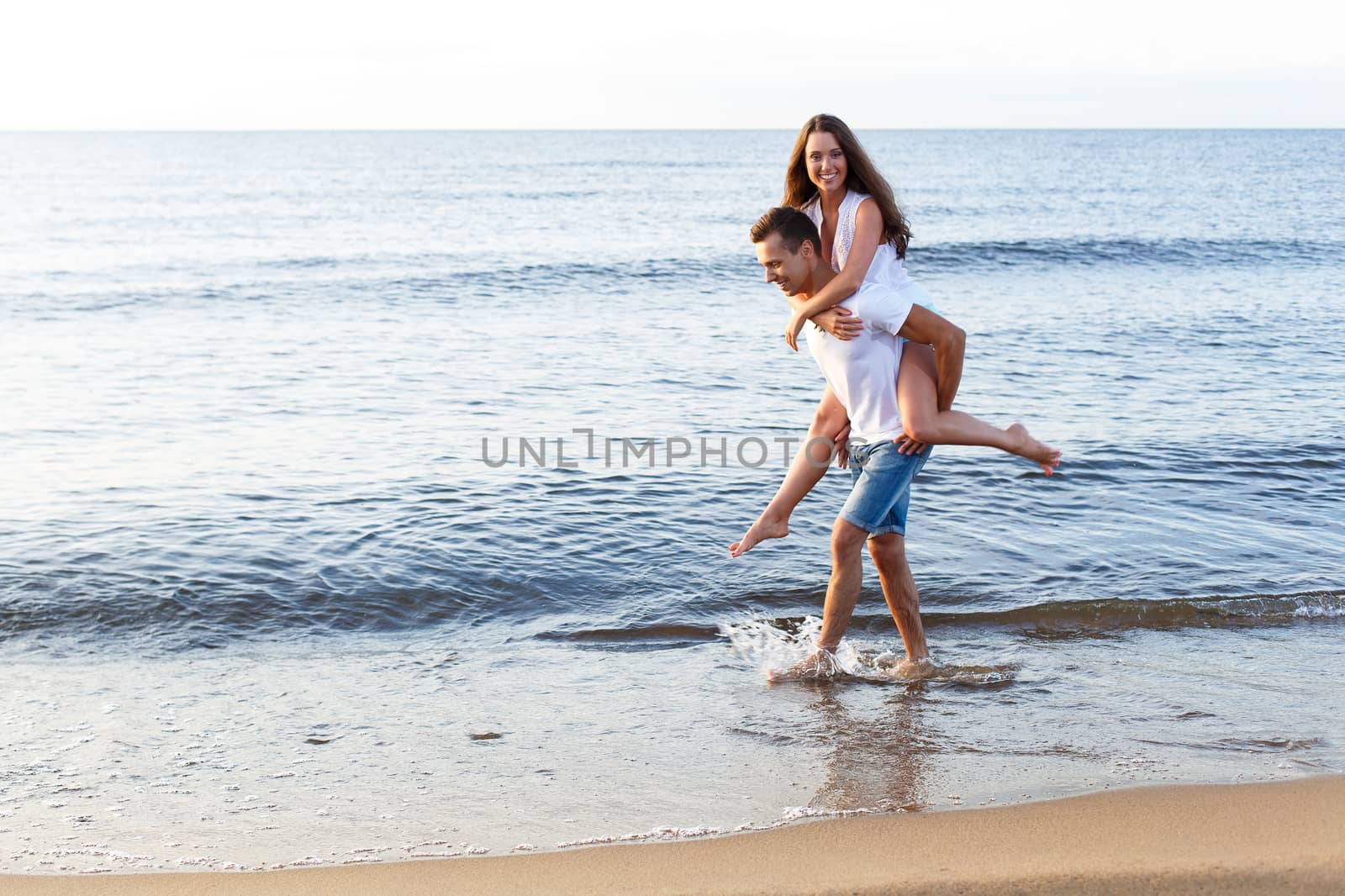 Summer, sea. Cute, lovely couple on the beach