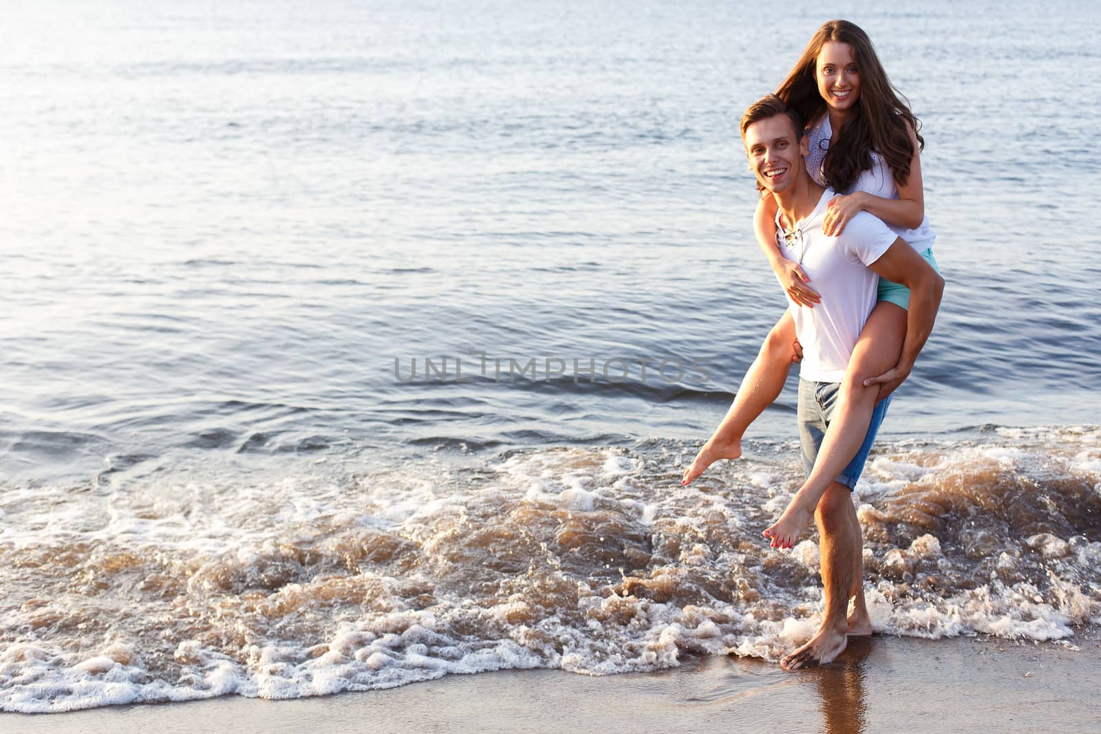 Summer, sea. Cute, lovely couple on the beach