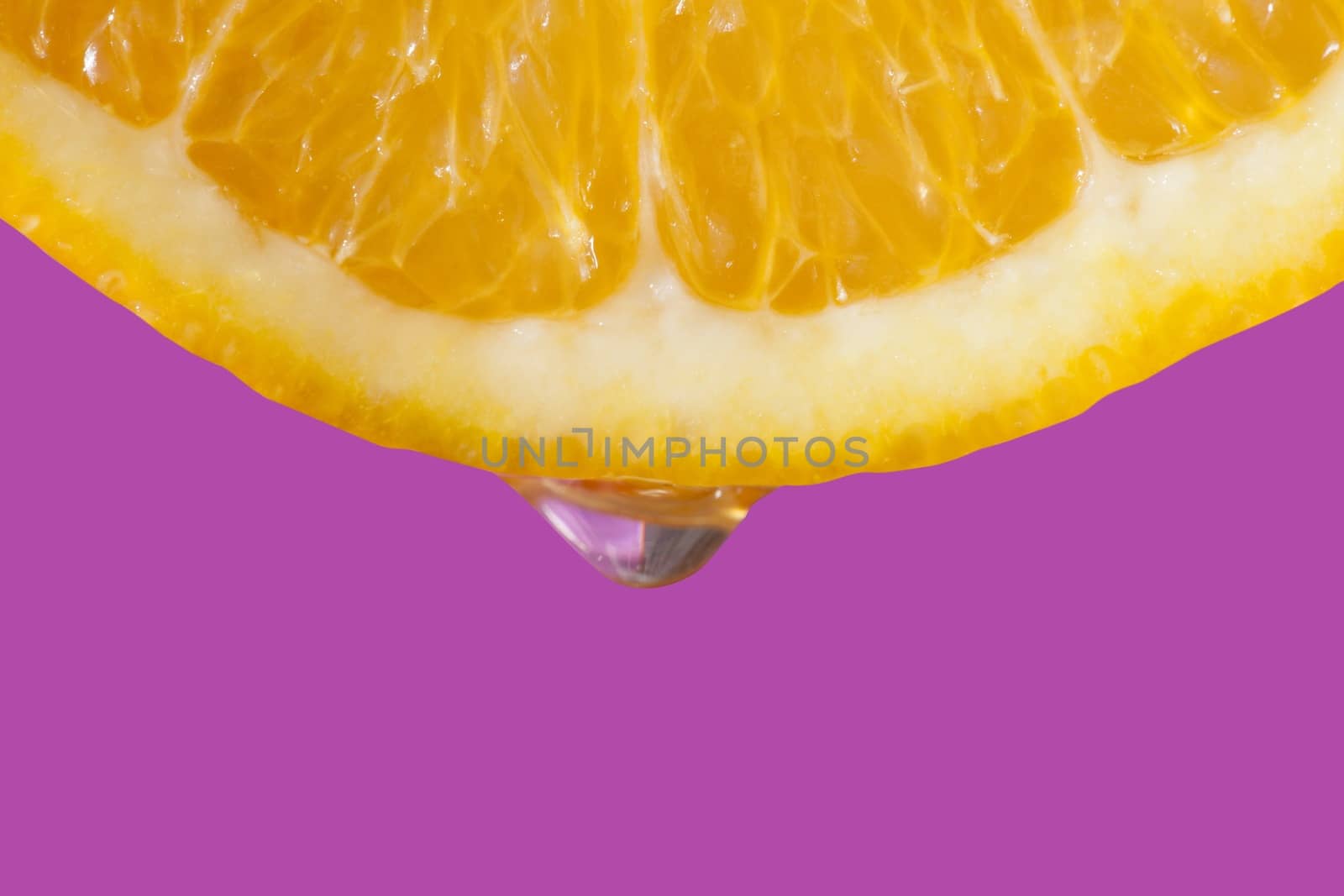 Macro picture of a slice of an orange with water drop