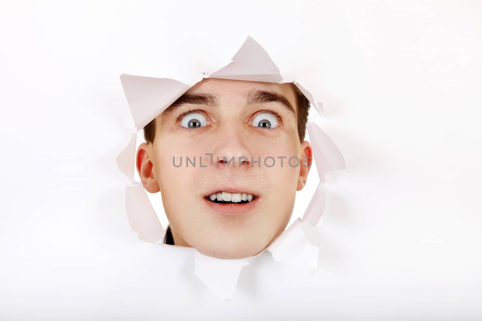 Surprised Teenager peeking through Paper Hole