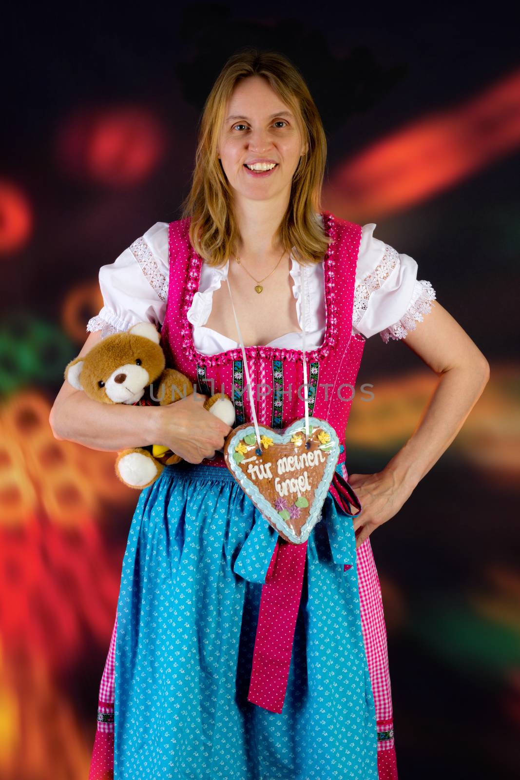 Woman with teddy and gingerbread at fun fair by gwolters