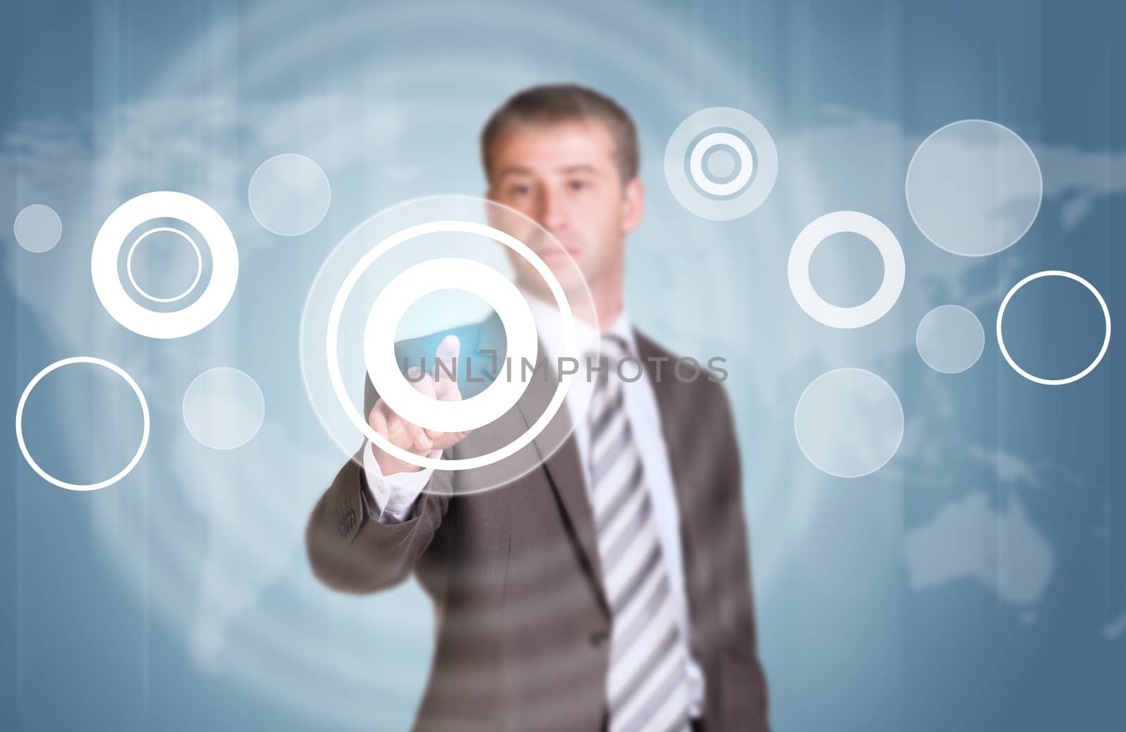 Businessman in suit finger presses virtual button. Graphs as backdrop