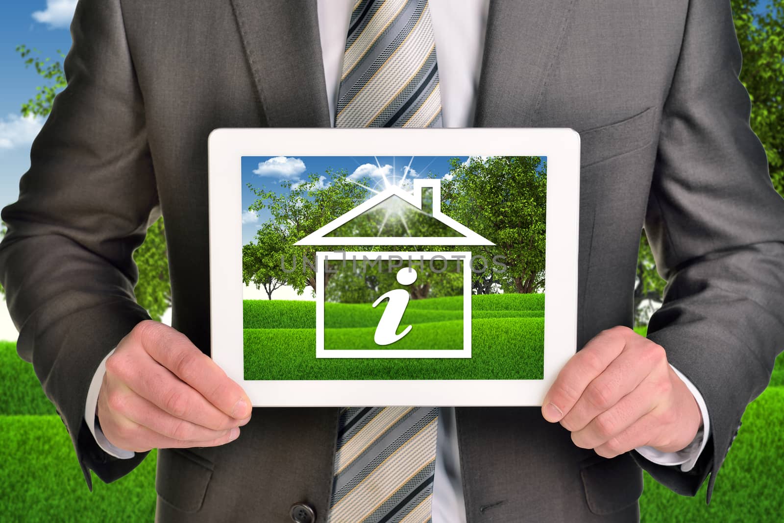 Two hands holding tablet pc. Picture of house icon with letter I on screen. Blured nature landscape on background