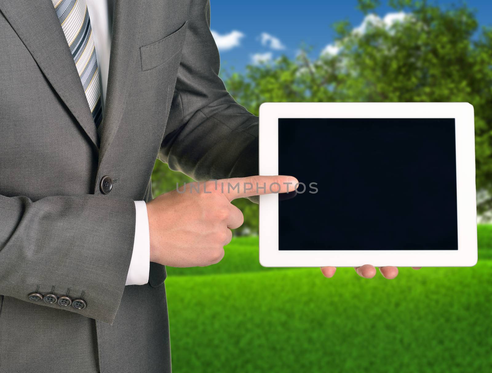 Two hands using tablet pc on blured nature landscape background