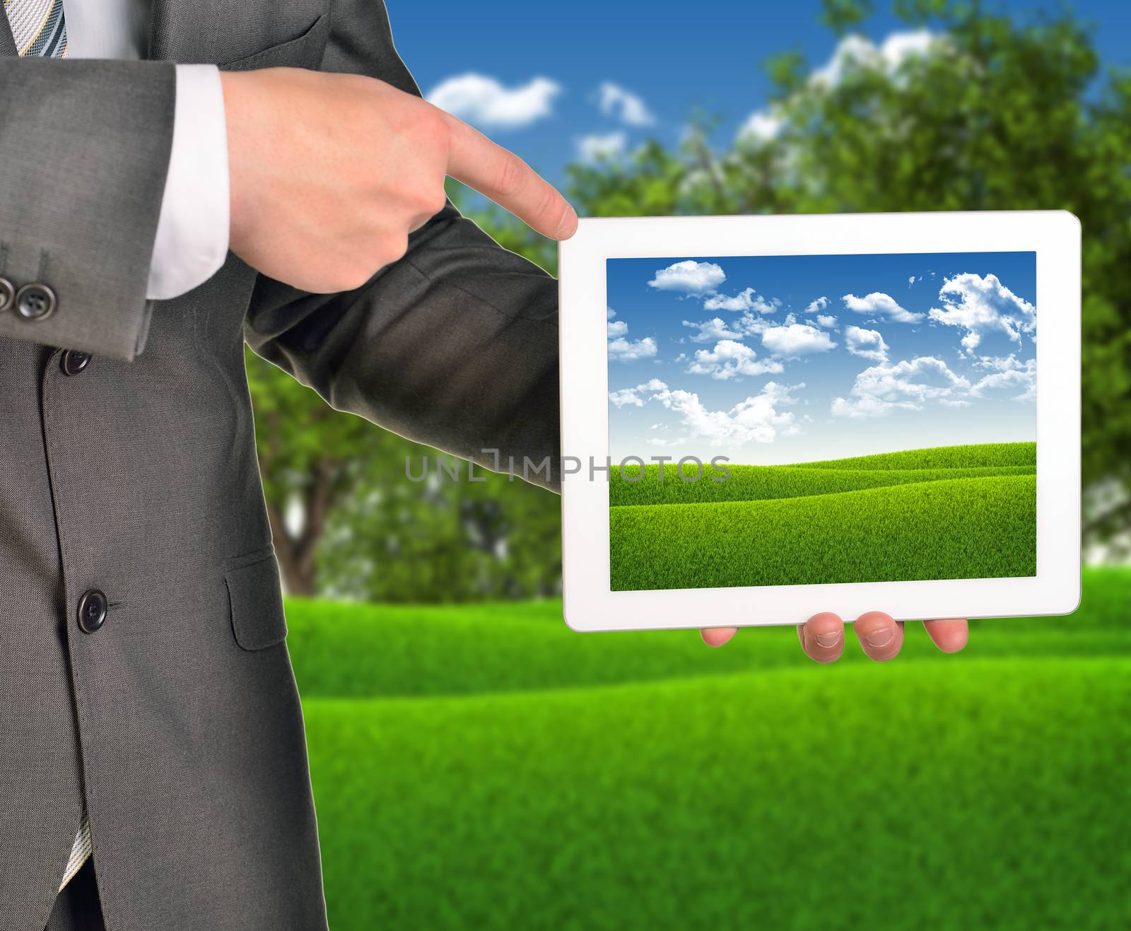 Two hands holding tablet pc on blured nature landscape background