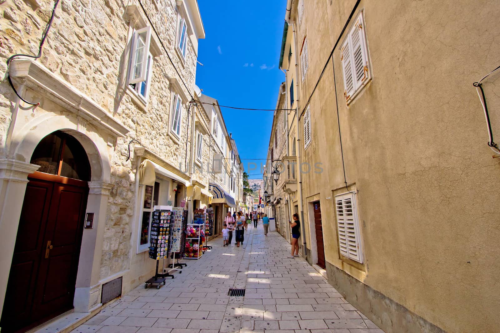 Pag, Croatia - July 19: Unidentified people on old stone mediterranean street on July 19, 2014 in island of Pag, Croatia. Pag is famous tourist destination in region of Dalmatia.