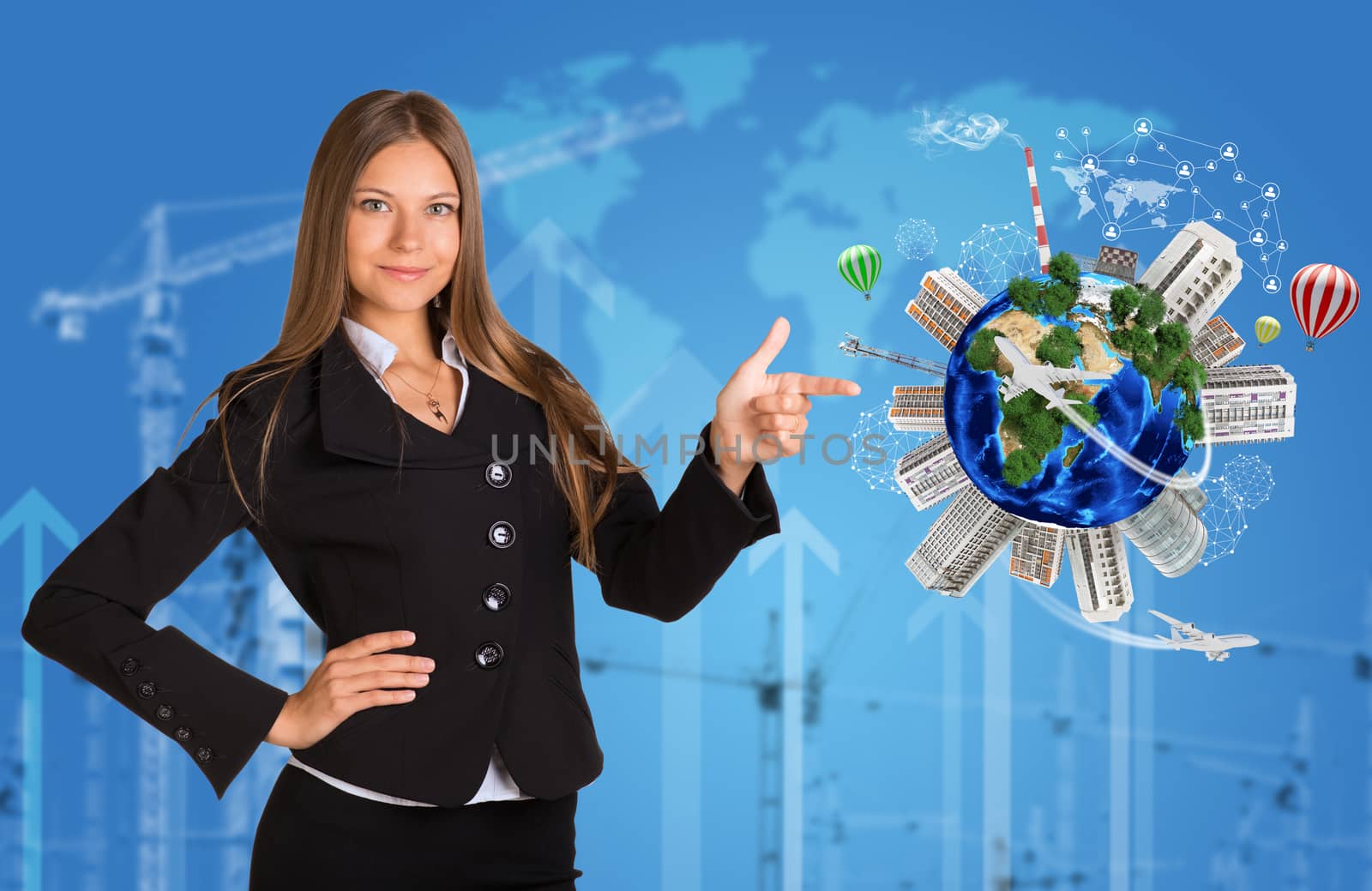 Beautiful businesswoman in suit finger points to Earth with buildings by cherezoff