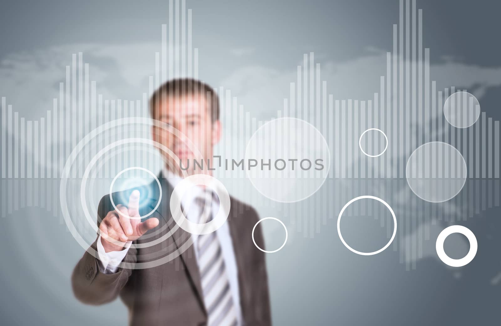 Businessman in suit finger presses virtual button. Graphs as backdrop