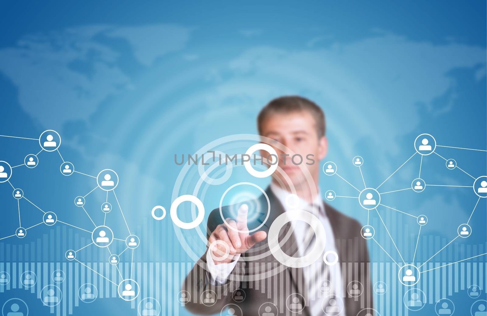 Businessman in suit finger presses virtual button. Graphs as backdrop