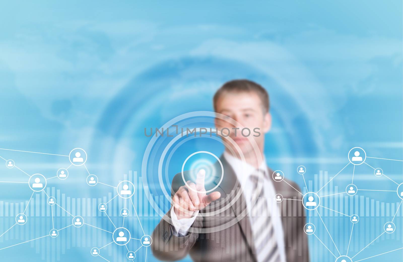 Businessman in suit finger presses virtual button. Graphs as backdrop