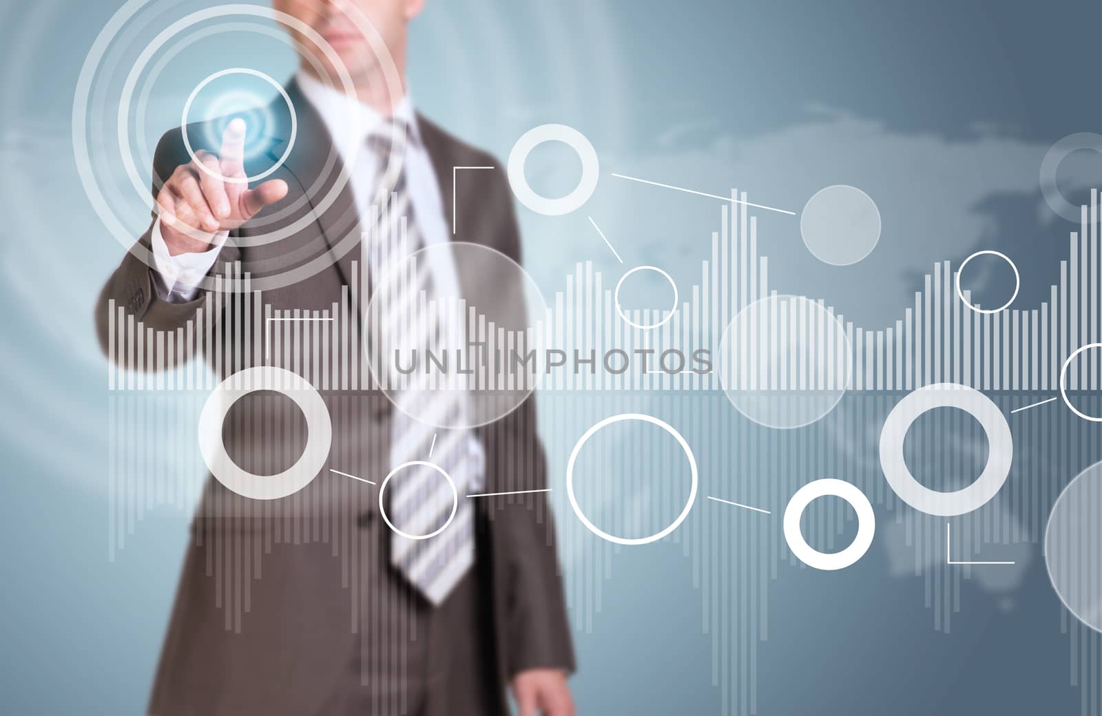 Businessman in suit finger presses virtual button. Graphs as backdrop