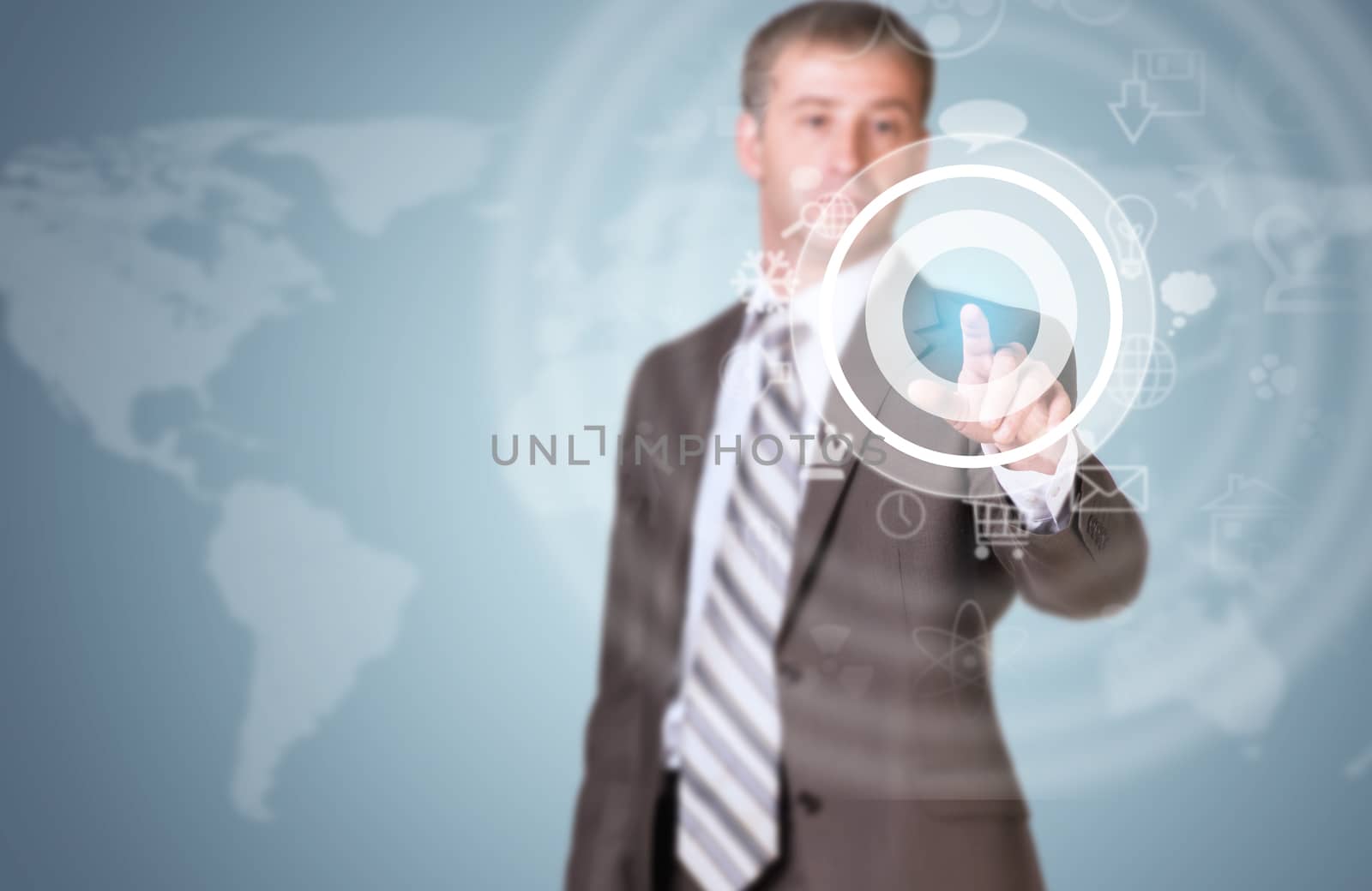 Businessman in suit finger presses virtual button. Graphs as backdrop