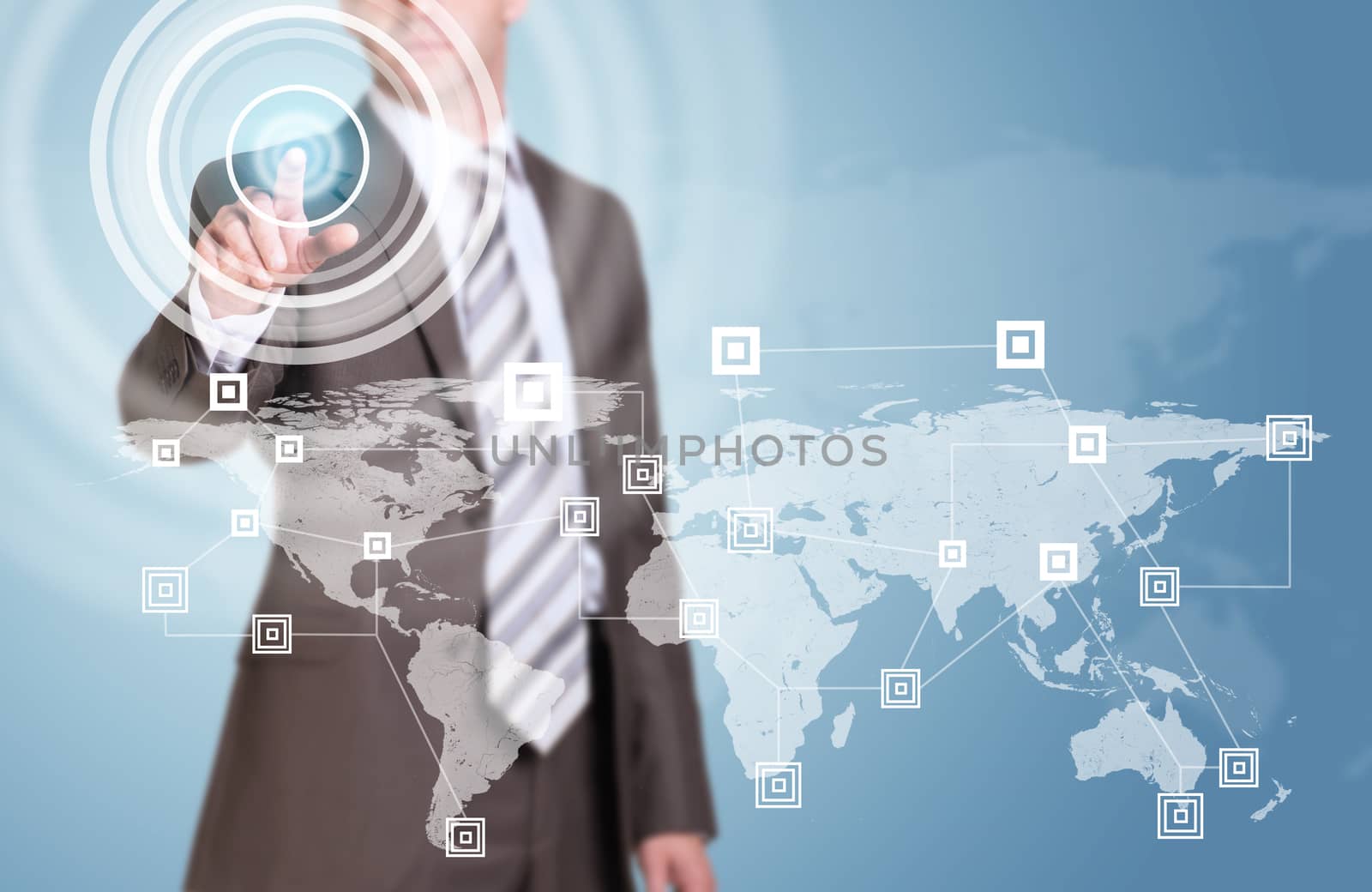 Businessman in suit finger presses virtual button. Network, graphs, circles and world map as backdrop