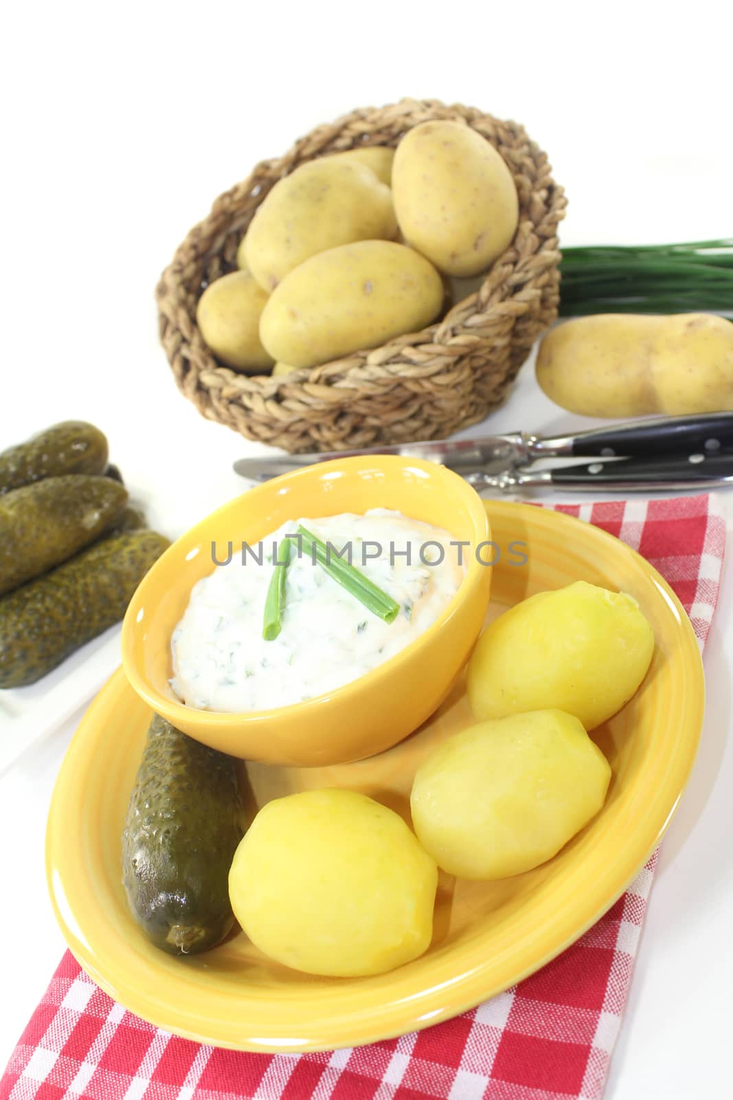 Herb curd with boiled potatoes and pickled cucumber