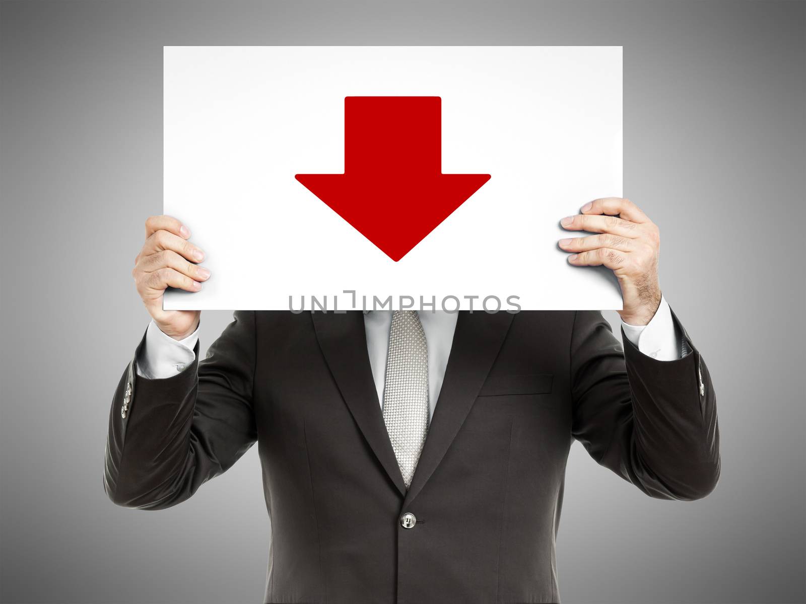 A business man holding a paper in front of his face with a red arrow