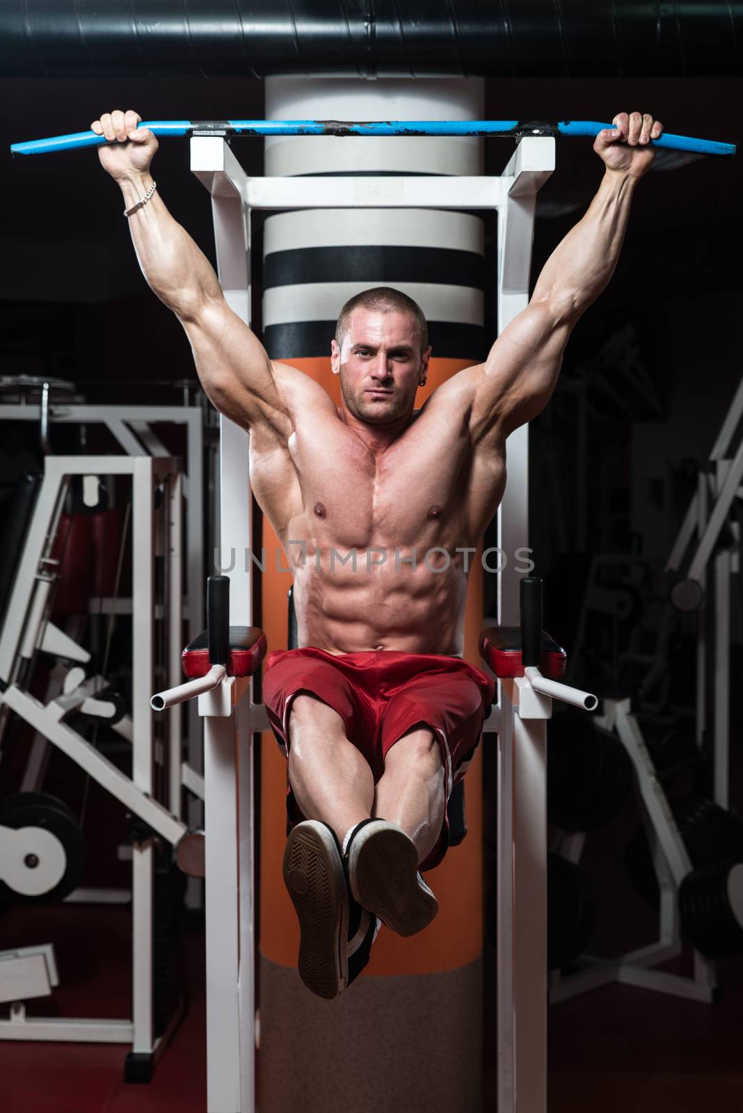 Young Man Doing Exercise For Abs by JalePhoto