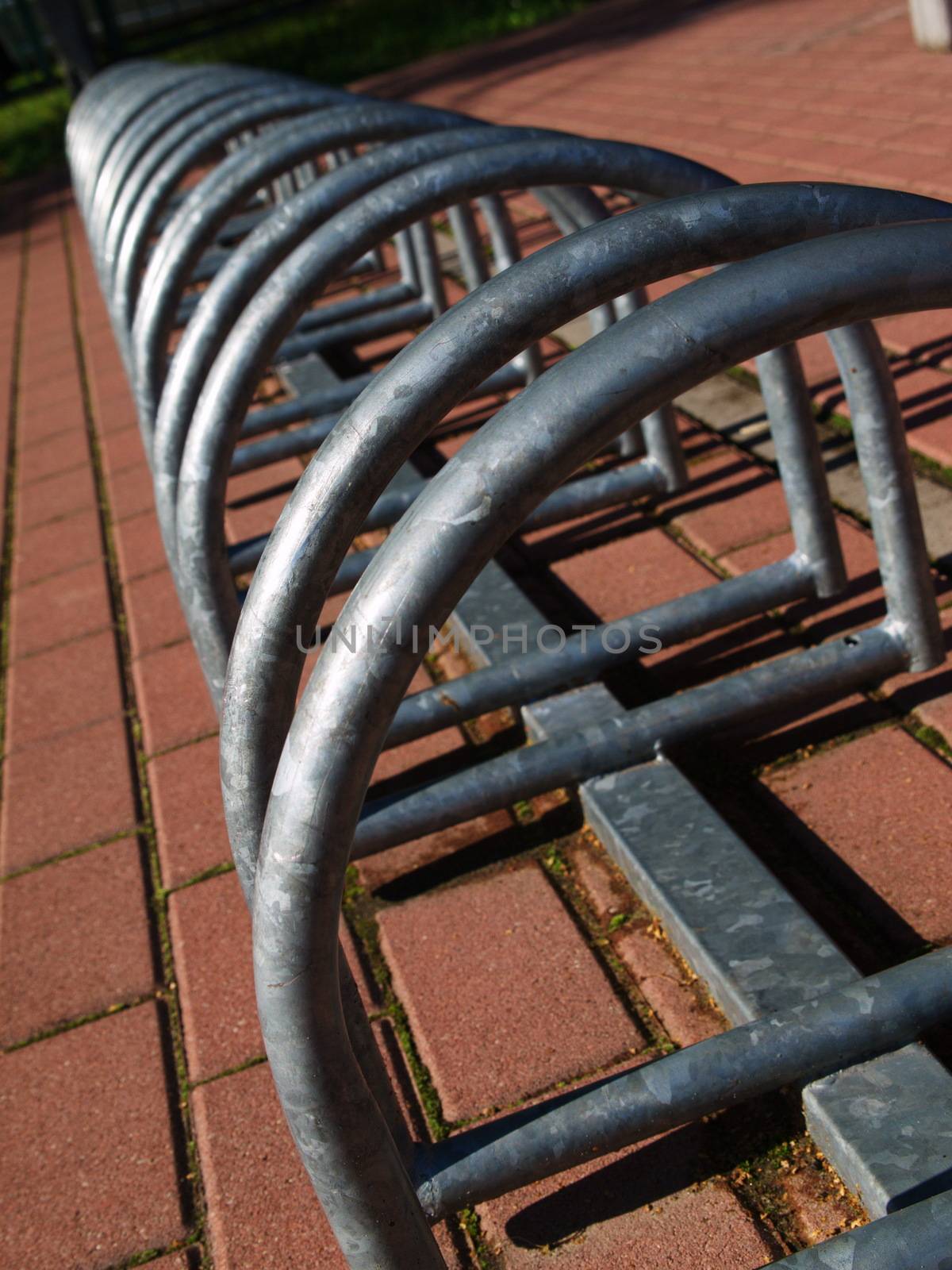 Metal spiral holder for bikes set up in front of store