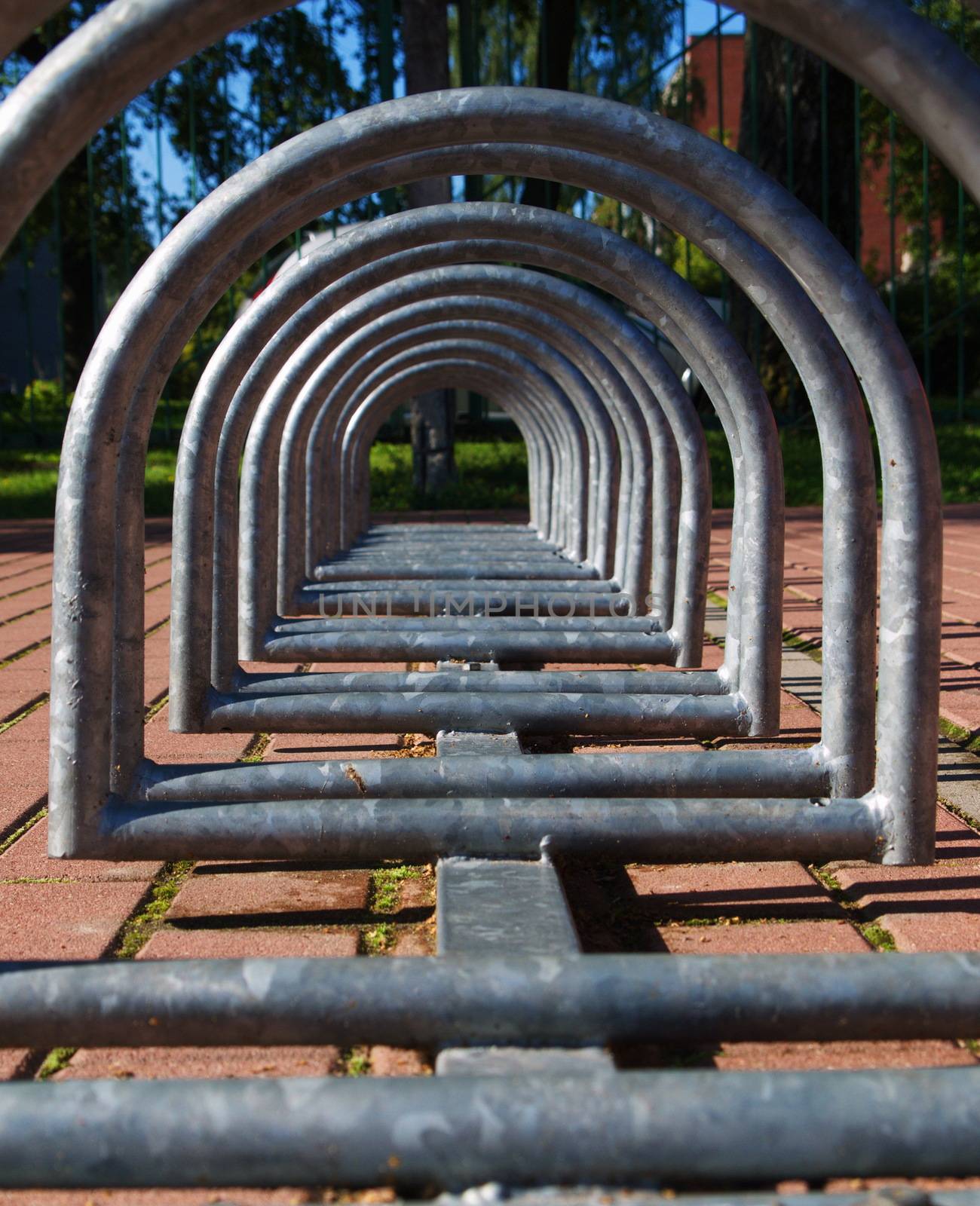 Metal spiral holder for bikes set up in front of store