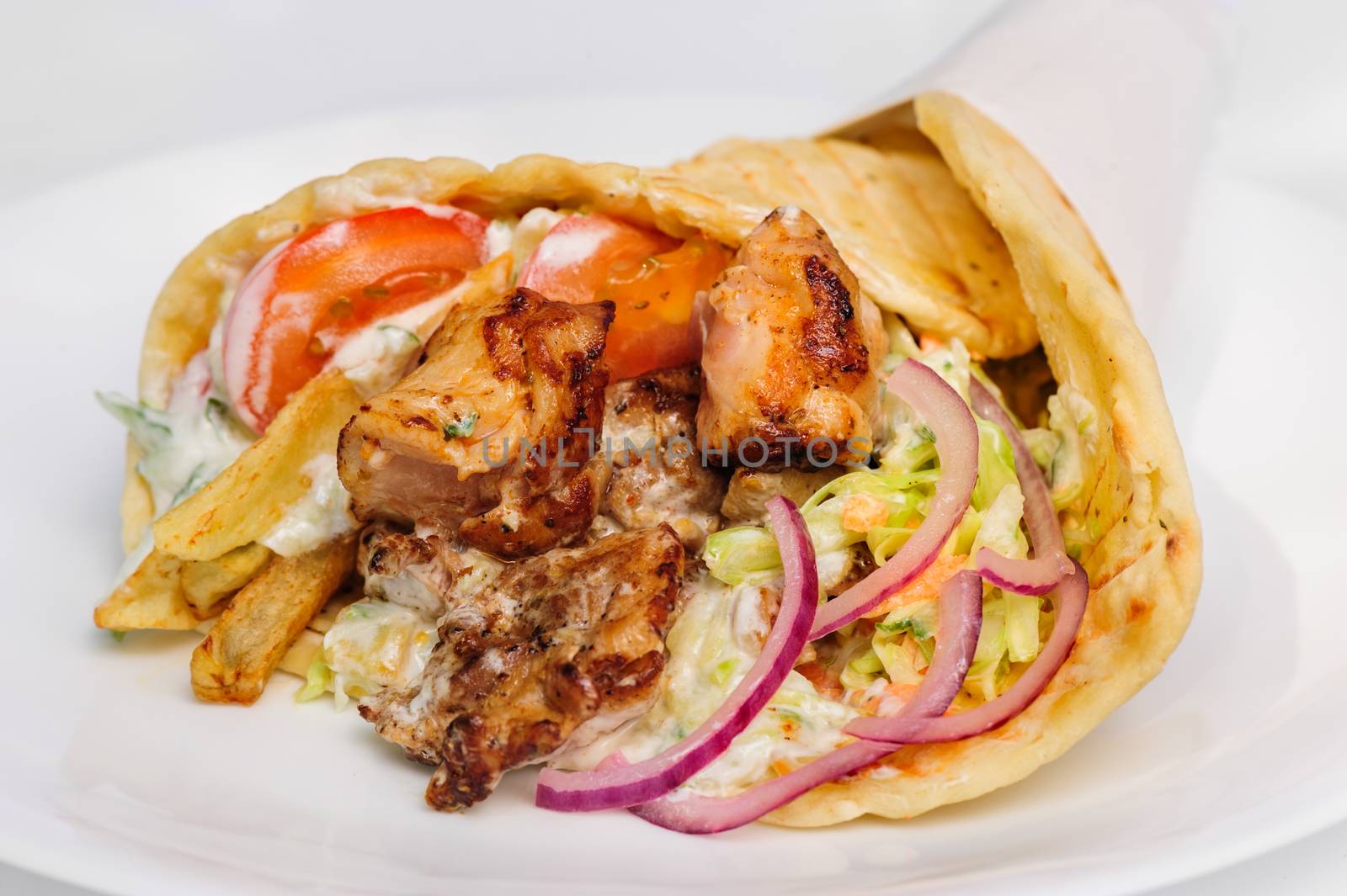 greek gyros stuffed with meat, salad, onion, tomato and potato