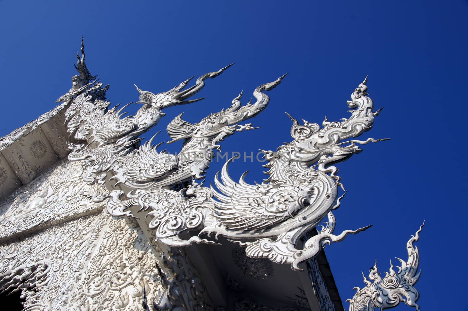 Modern Buddhist sculpture,.
White temple in Thailand.