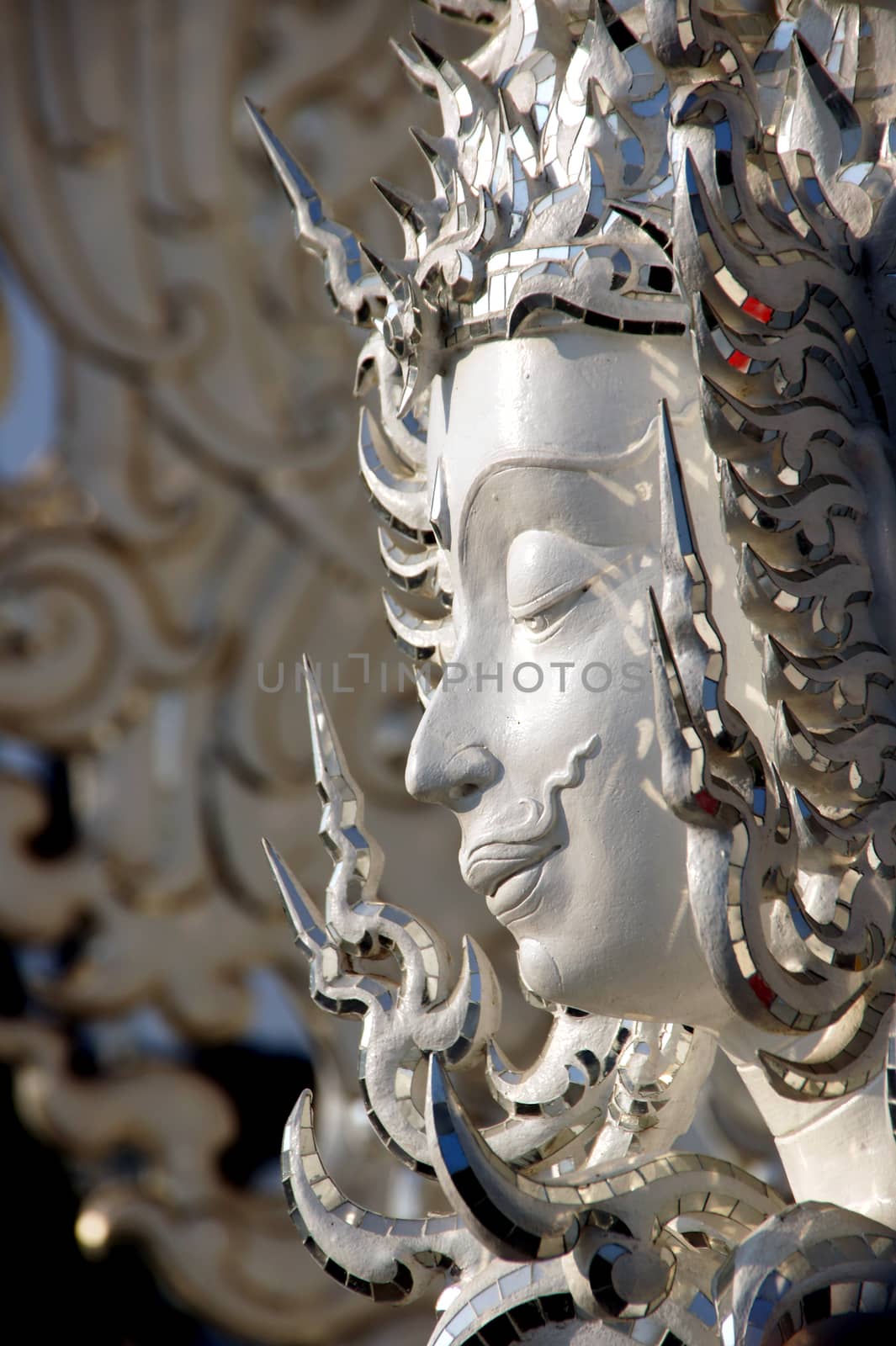 Modern Buddhist sculpture,.
White temple in Thailand.