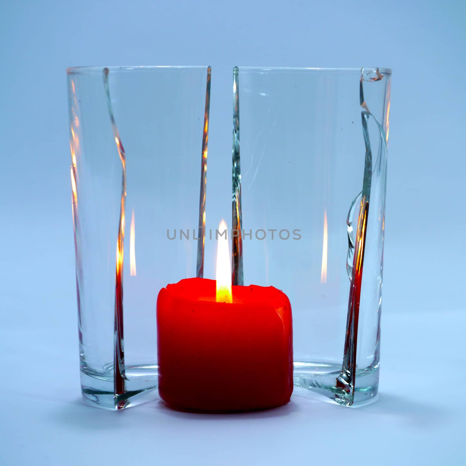Red candles in glass cracking. by Noppharat_th