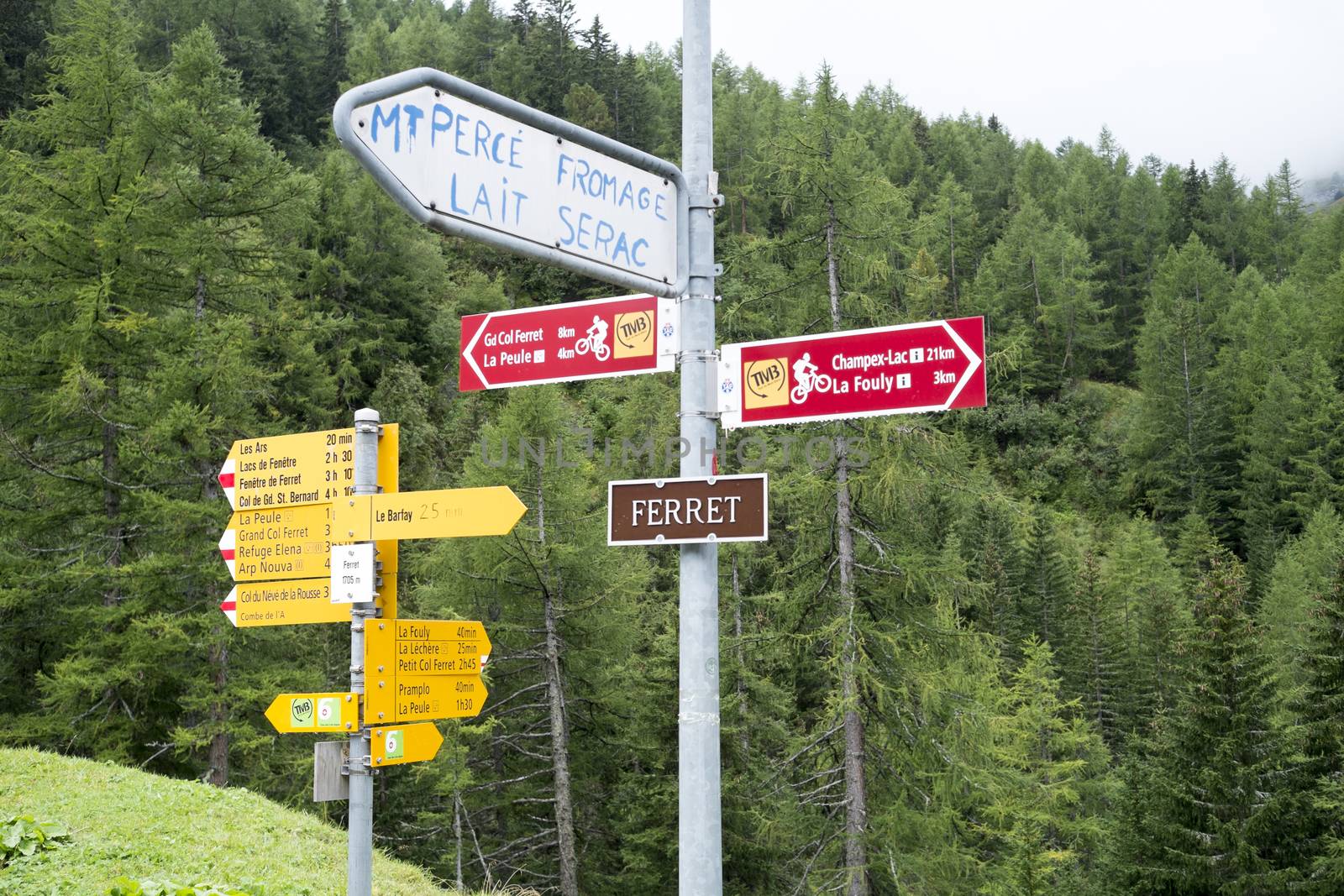 FERRET, SWITZERLAND - AUGUST 30: Tour du Mont Blanc direction signs. The popular tour goes through France, Italy and Switzerland, and is clearly signalised throughout.. August 30, 2014 in Ferret.