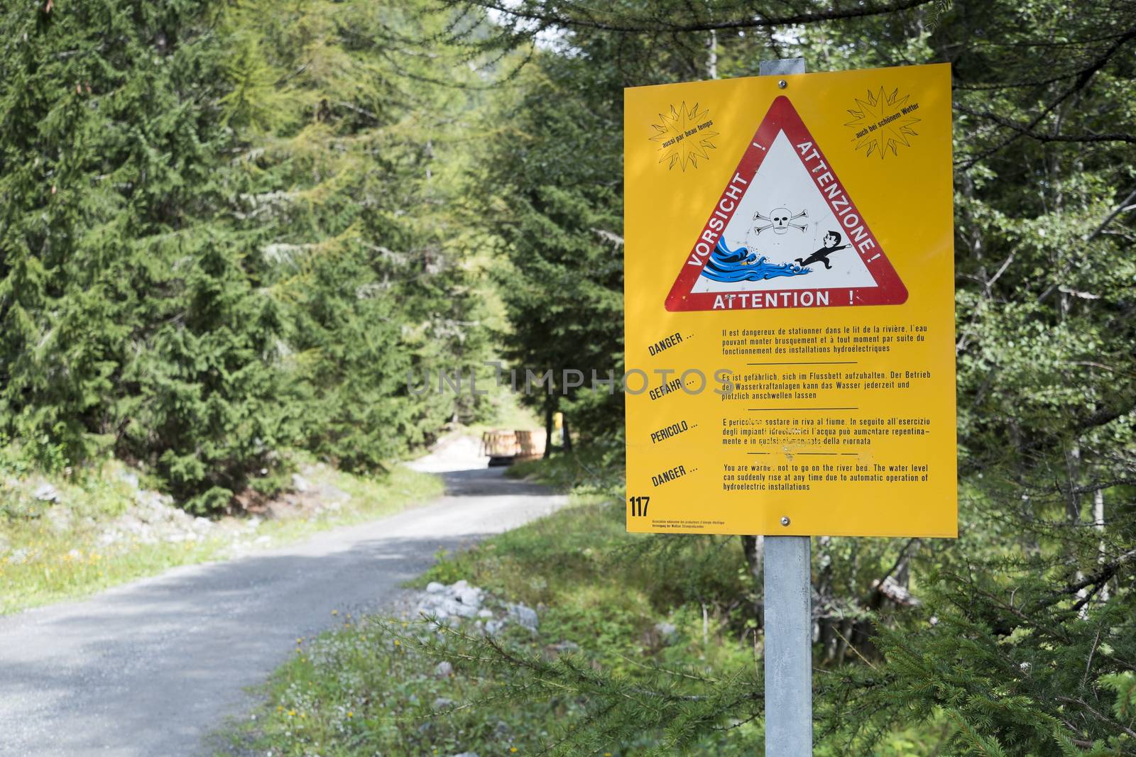 LA FOULY, SWITZERLAND - AUGUST 30: Flash flood warning sign on Mont Blanc tour path. The tour goes through three countries and is clearly signalised throughout. August 30, 2014 in La Fouly.