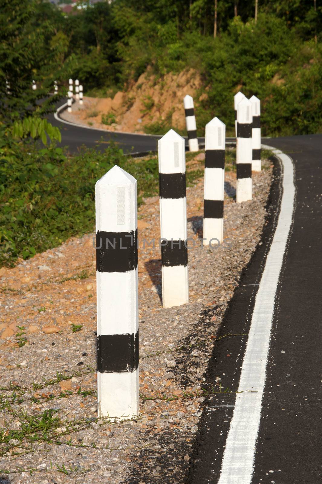 Stone pillars prevent accidents on the road curved.