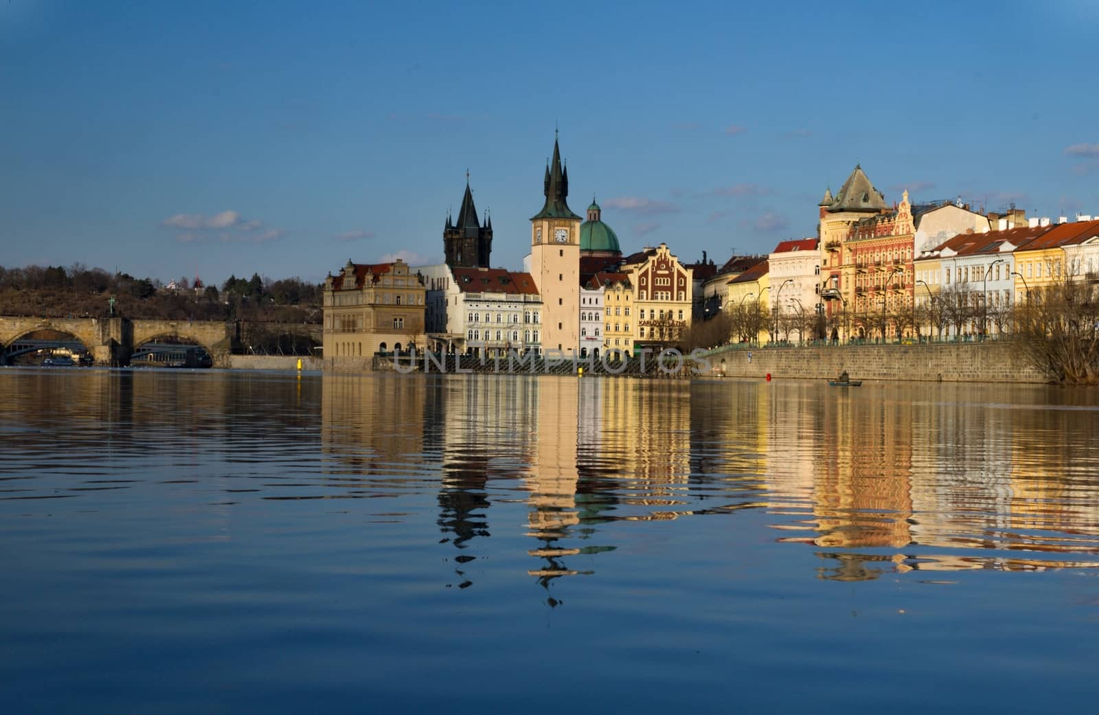 Photo shows various historical houses, Vltava river, bridges and other architectural details.