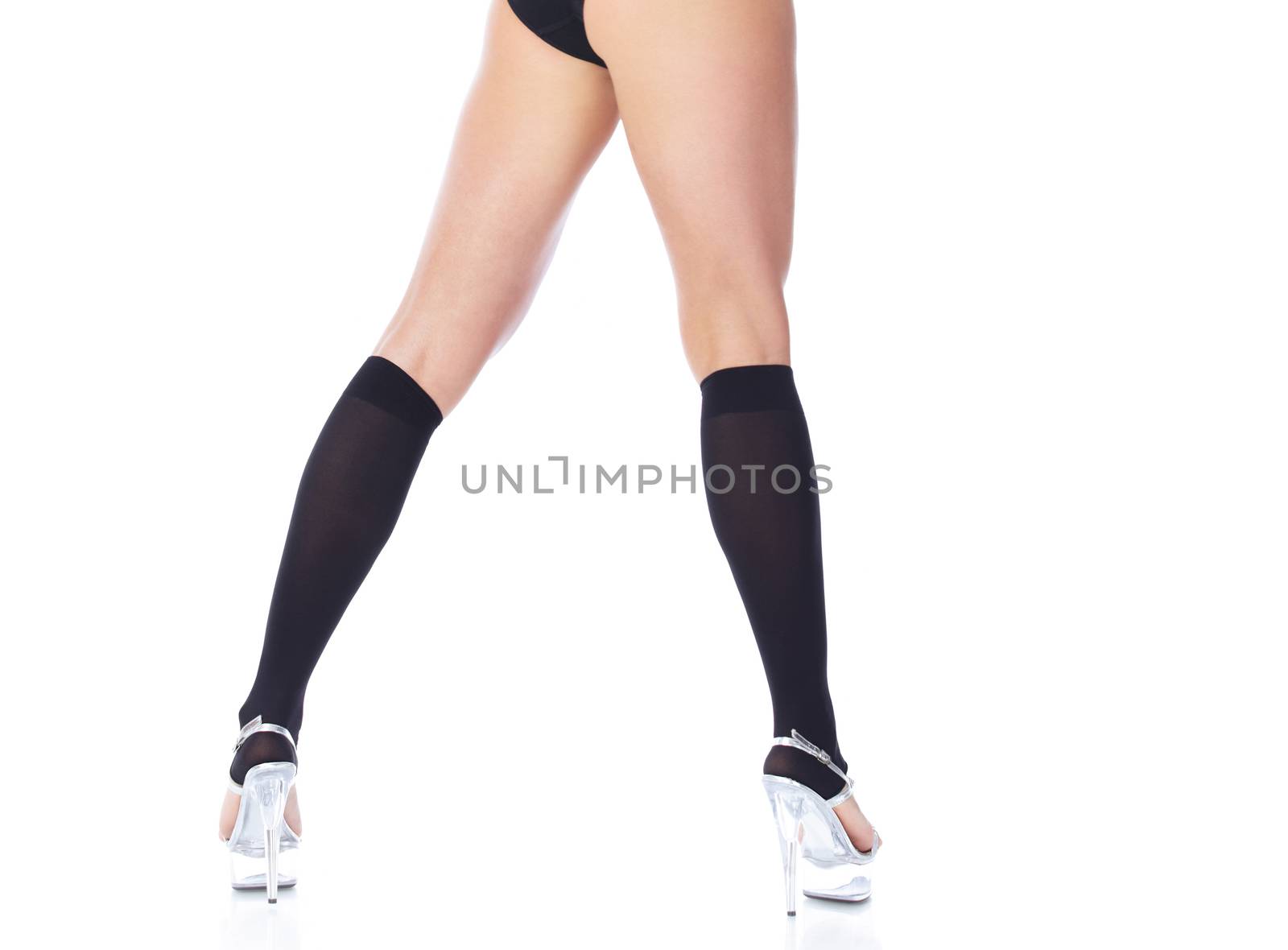 Legs of woman in lingerie in high heel shoes