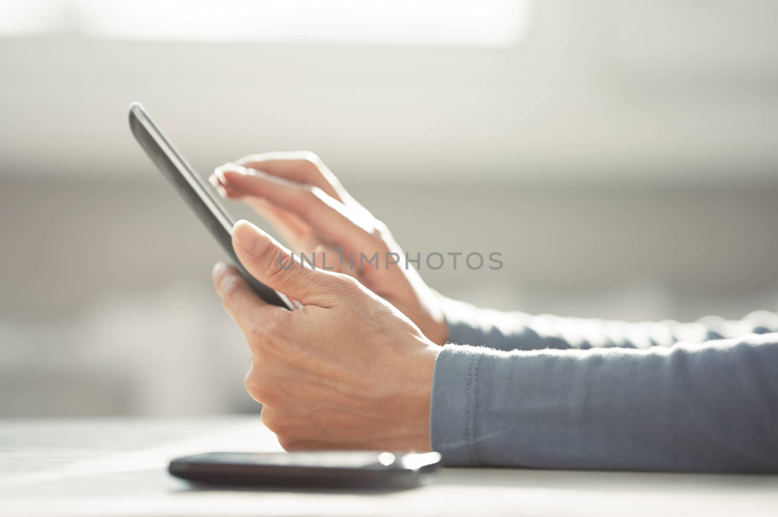 Hands of woman working with digital tablet