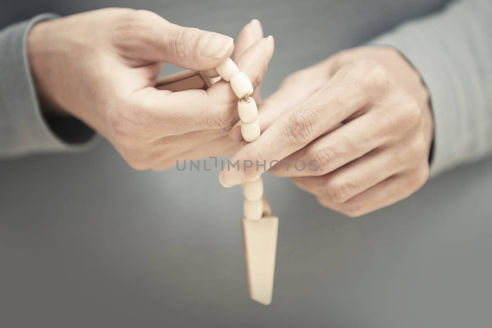 Hands with rosary beads. Close-up view