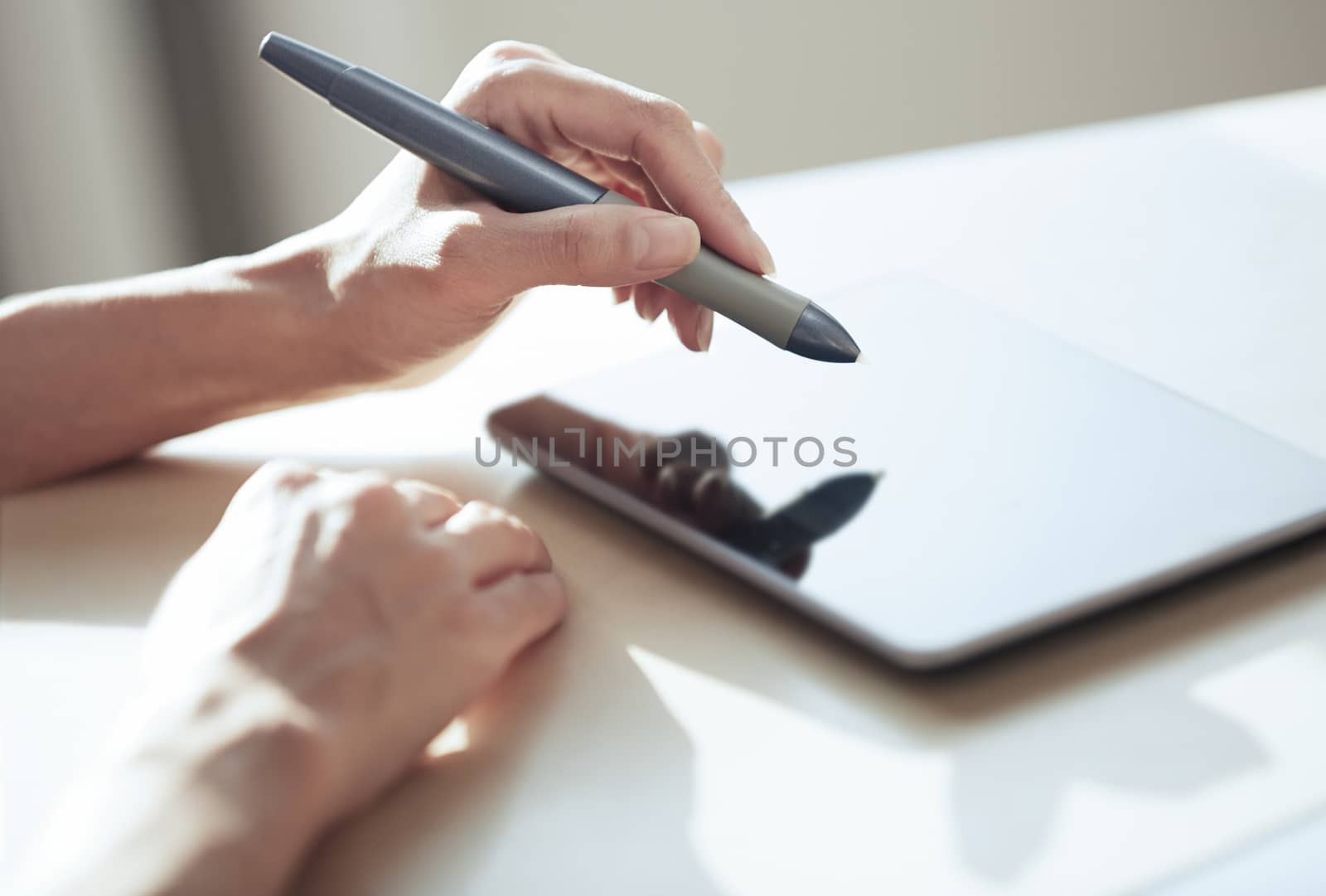 Hands of woman working with digital tablet