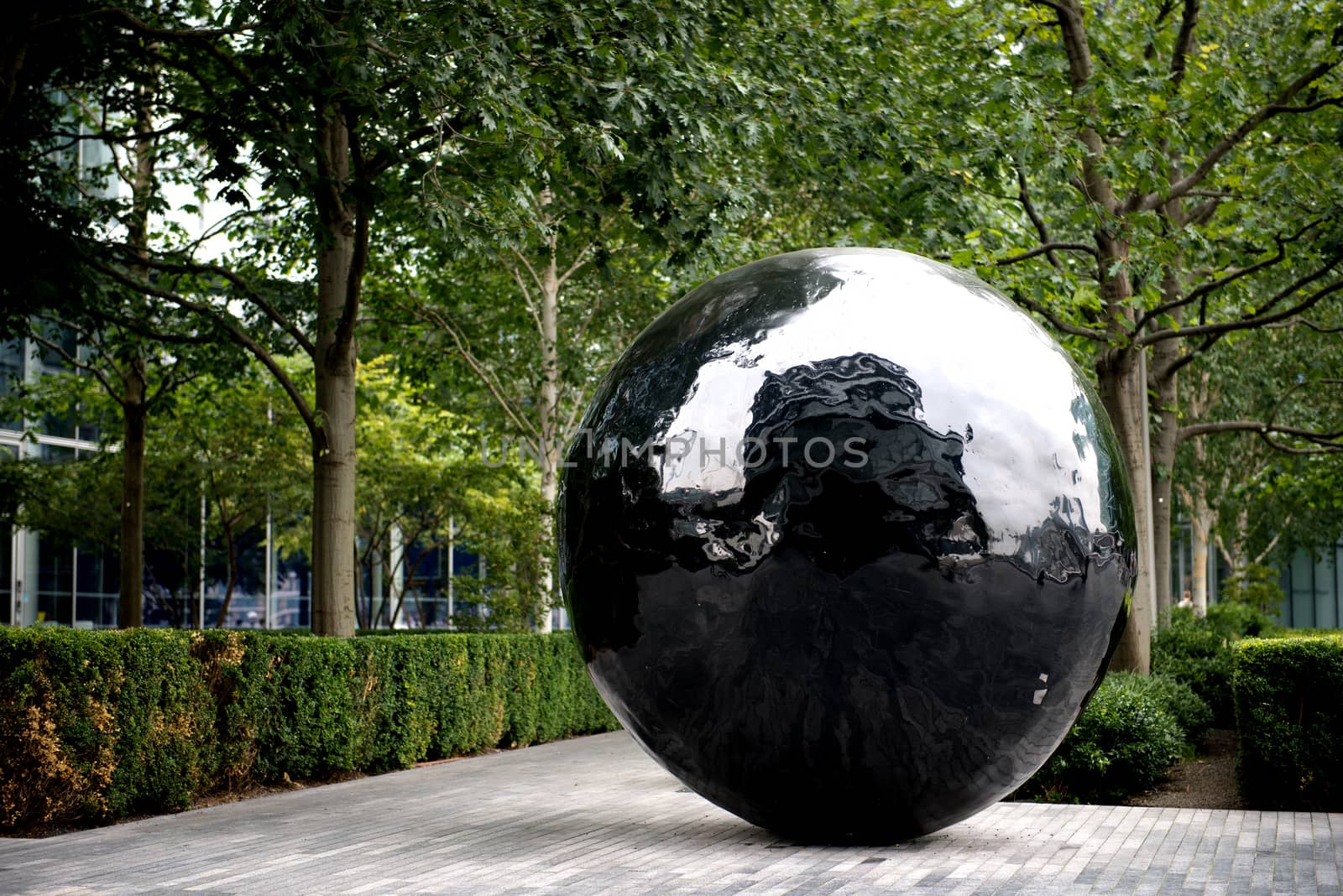 Big black sphere sculpture on the bank of River Thames by MohanaAntonMeryl