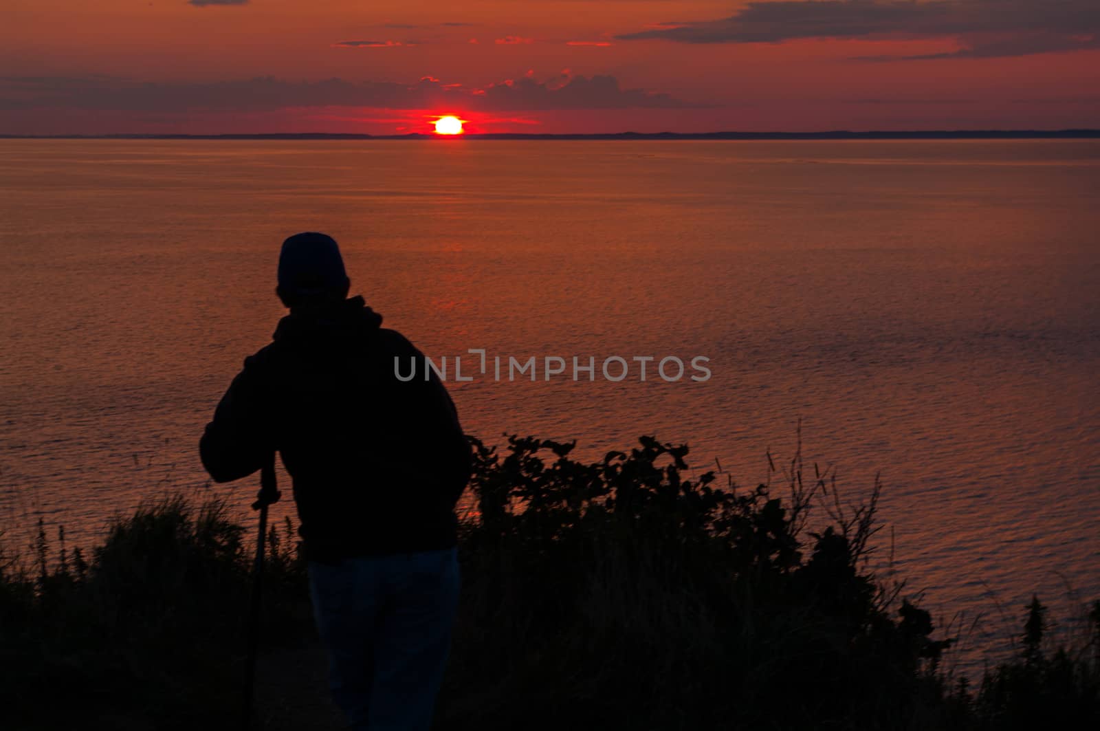 Woman relaxing as the Sunsets at Southern Head on Grand Maman