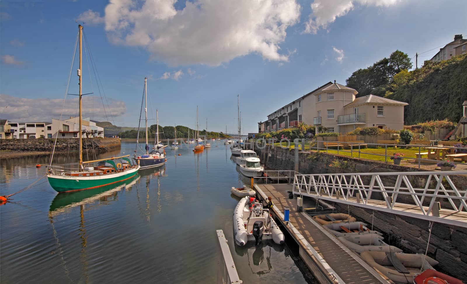 Moored yachts and riverside dwellings are the main features of Porthmadog, in Wales, UK.