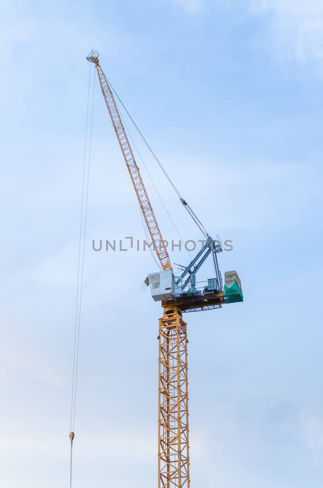 Yellow crane in a construction site .
