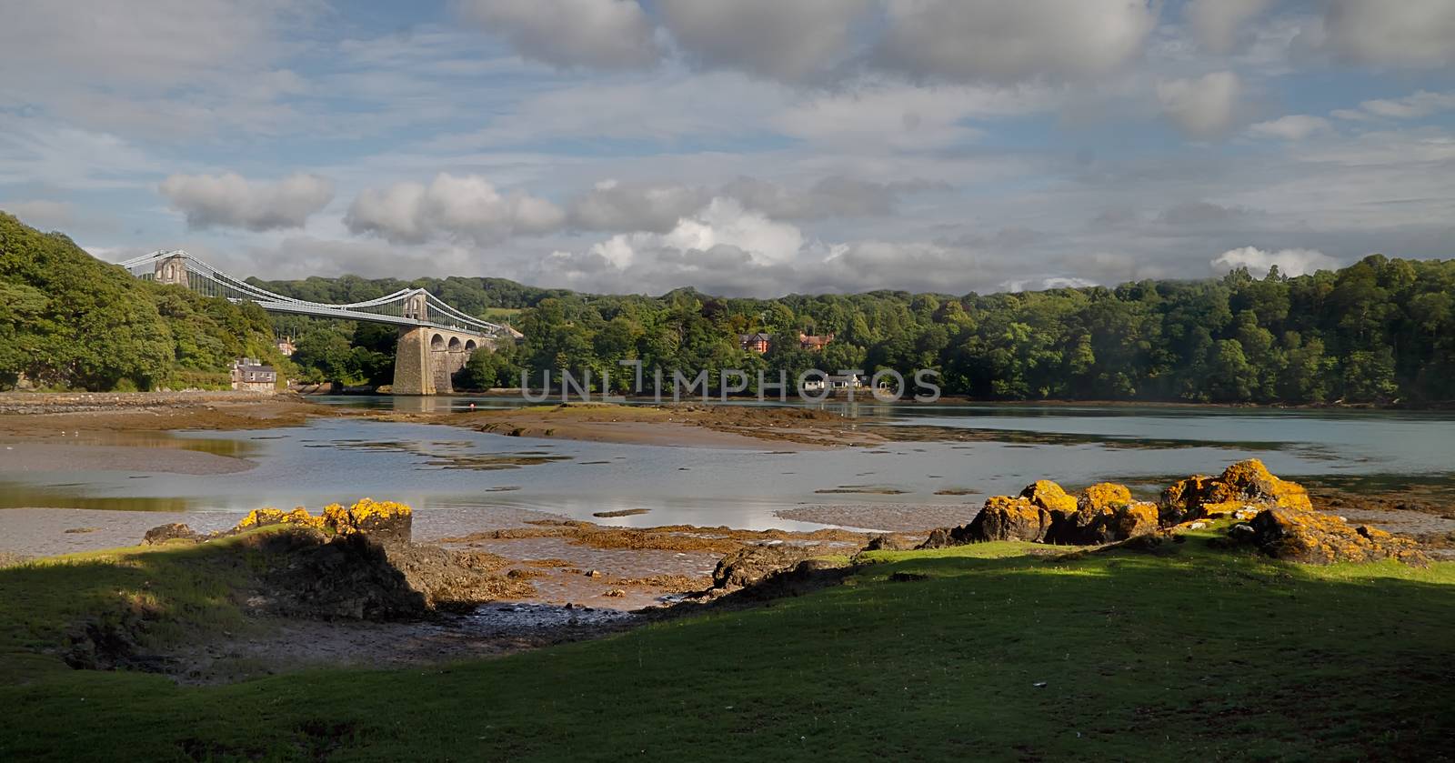 The Menai suspension bridge was built by Thomas Telford and opened in 1826. It connects Anglesey to the Welsh mainland.