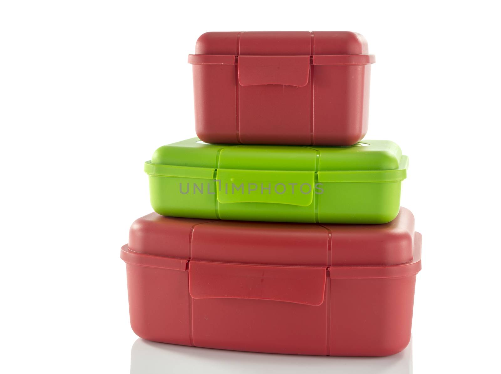 stack of red and green lunchboxes isolted on white